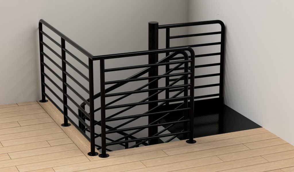 Black metal custom railing encloses the top of a spiral staircase, set against white walls and light wood flooring. The railing features horizontal bars and vertical supports, showcasing elegant custom ironworks.